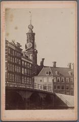 Historical view of Muntplein square in Amsterdam with the Munttoren tower and the Coffeehouse de Munt, taken from Oude Turfmarkt near Rokin, featuring old English Houses and Doelenbrug bridge in foreground