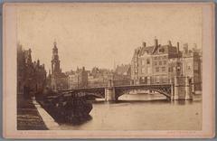 Halvemaansbrug bridge over Binnen Amstel canal with Munttoren tower and Muntplein square in the background, historic Amsterdam view circa 1881-1883