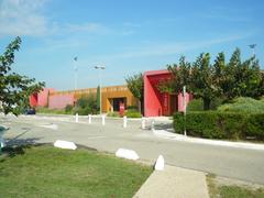 Avignon Airport terminal modern glass building with parked cars and bright blue sky