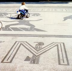 Child playing near fascist symbols at Foro Italico in Rome