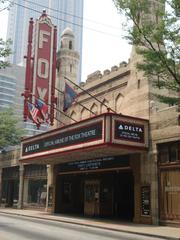 View of Fox Theatre in Atlanta with marquee and palm trees under blue sky