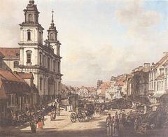 View of Krakowskie Przedmiescie street in Warsaw, Poland with historic buildings and cars