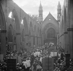 Corpus Christi service and ceremony at the roofless St George's Cathedral in Southwark, London in 1944 with congregation and Guild of the Blessed Sacrament banners