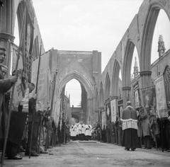 Corpus Christi service with crucifix procession at the altar in roofless St George's Cathedral, Southwark, London, 1944