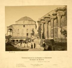 Ruins of the Corinthian colonnade at the north side of the west facade of Hadrian's Library with the 15th-century Fethiye Mosque and people including soldiers and workers