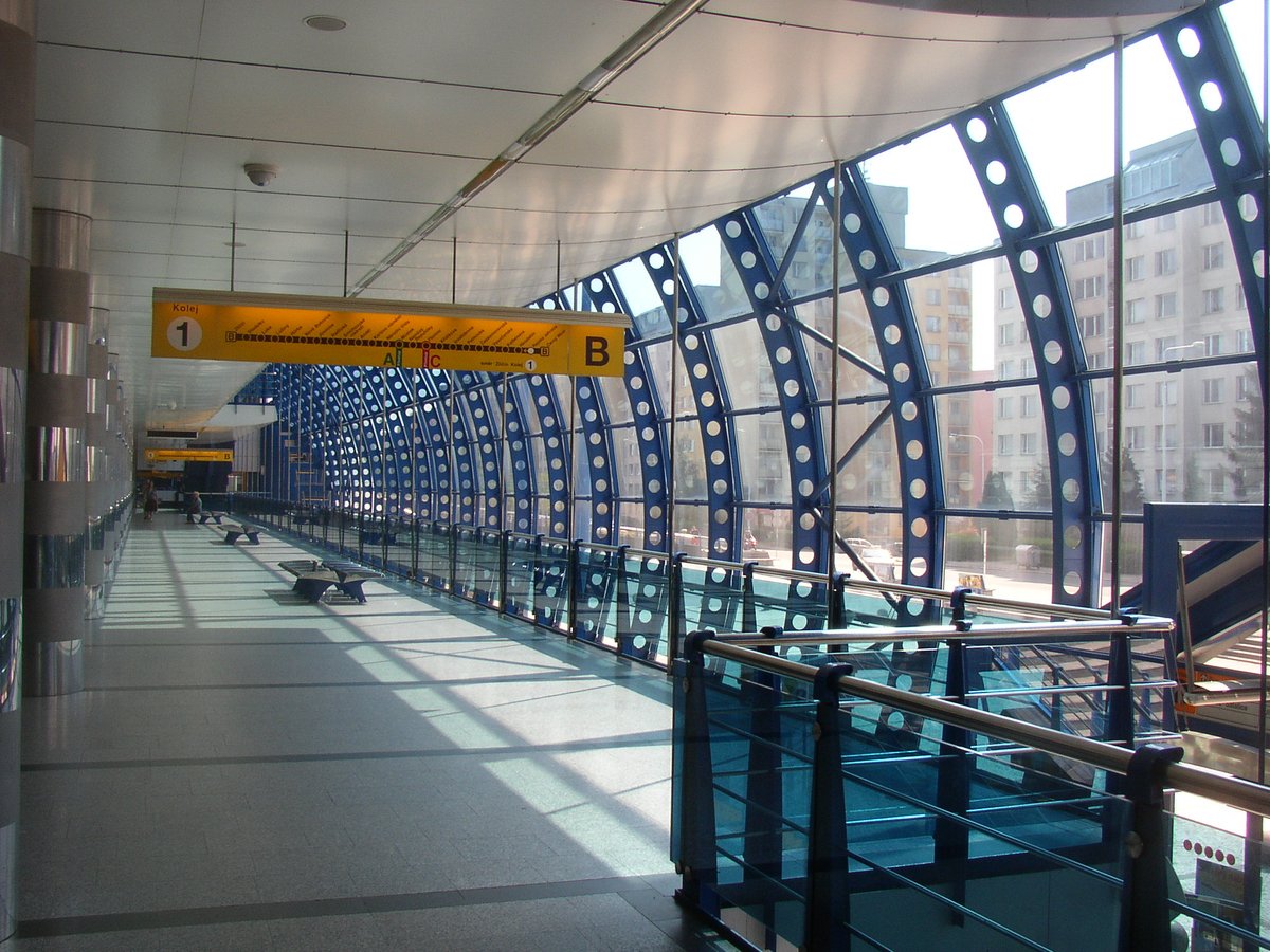 Rajska zahrada metro station platform with yellow and white walls and passengers waiting in Prague