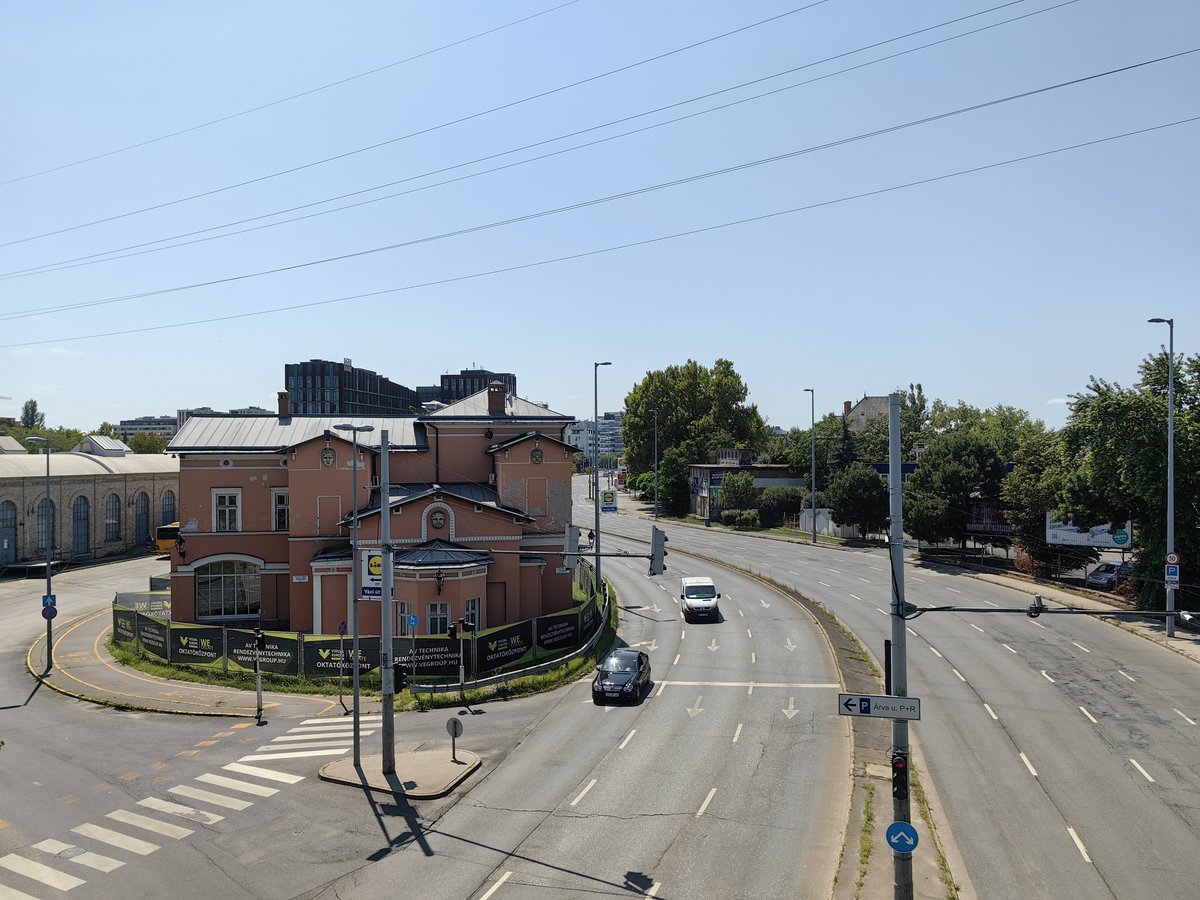 Street view of Váci út in Budapest with shops and cars