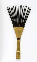 Palmwood hair comb with intricate carvings from Indonesia