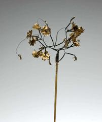 Traditional Indonesian hair ornament with golden bee flowers