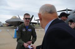 US Air Force pilot Brett Vongroven giving F-22 Raptor squadron sticker to fan at 2011 Australia International Airshow in Geelong