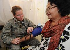 U.S. Air Force Maj. Shannon Faber checking patient's blood pressure at mobile field hospital in Padang Indonesia 2009