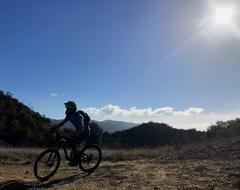 Mountain biking trail in Topanga State Park with riders on a sunny day