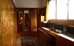 Private wardrobe in Villa Müller with wooden shelves and hanging space