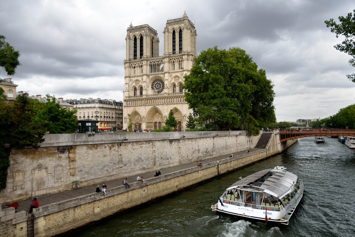Notre-Dame de Paris Cathedral and Batobus riverboat on the Seine River, Paris