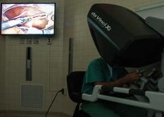 Dr. Samuel Cancel-Rivera operating with robotic surgical system at William Beaumont Army Medical Center
