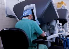 Surgeon Dr. Samuel Cancel-Rivera operating with a robotic surgical system and 3D imaging at William Beaumont Army Medical Center