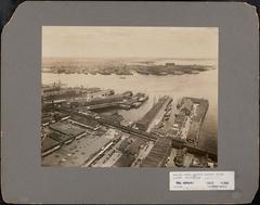 Aerial view of Boston Harbor showing docks and waterfront with Custom House Tower in foreground