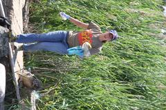 Volunteer Katherine Keller-Miller from Old Dominion University collecting trash at Craney Island Dredged Material Management Area in Portsmouth, Virginia