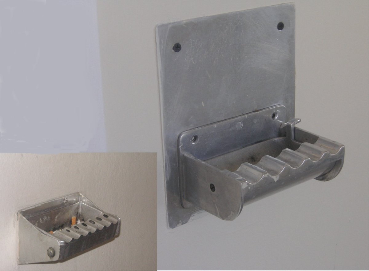 Wall-mounted ashtray with a removable lid for easy cleaning, located in the ORF Funkhaus corridor in Vienna