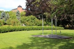 Showers in Stadsträdgården park with Uppsala Castle in the background