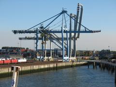 Port cranes at Zeebrügge port in Belgium under a cloudy sky