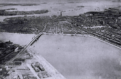 Aerial view of Boston with views of Atlantic Ocean, Custom House Tower, and MIT campus buildings from 1923