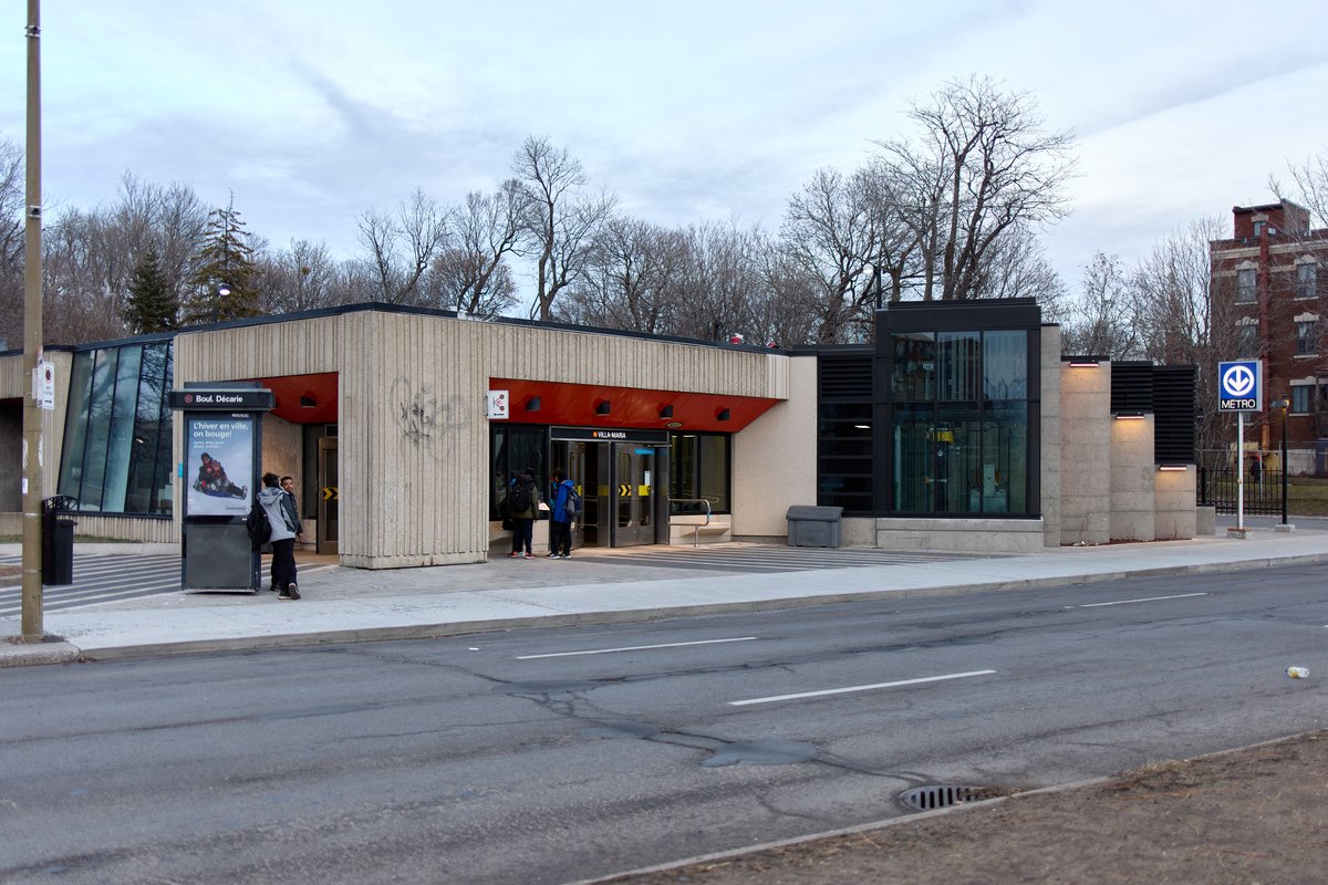Villa-Maria metro station platform with passengers and trains