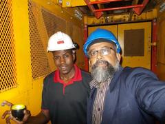 Tourist Rudolph A. Furtado and Gold Mine Guide Michael Tshivule on mine lift