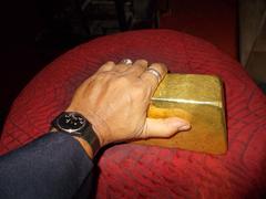 Hand holding a 12.5 kg gold ingot valued at US$460,000