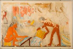 Ancient Egyptian tomb painting showing men preparing fish