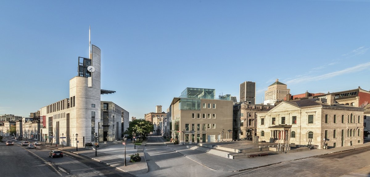 Pointe-à-Callière archaeological and history museum in Montreal with city skyline at sunset