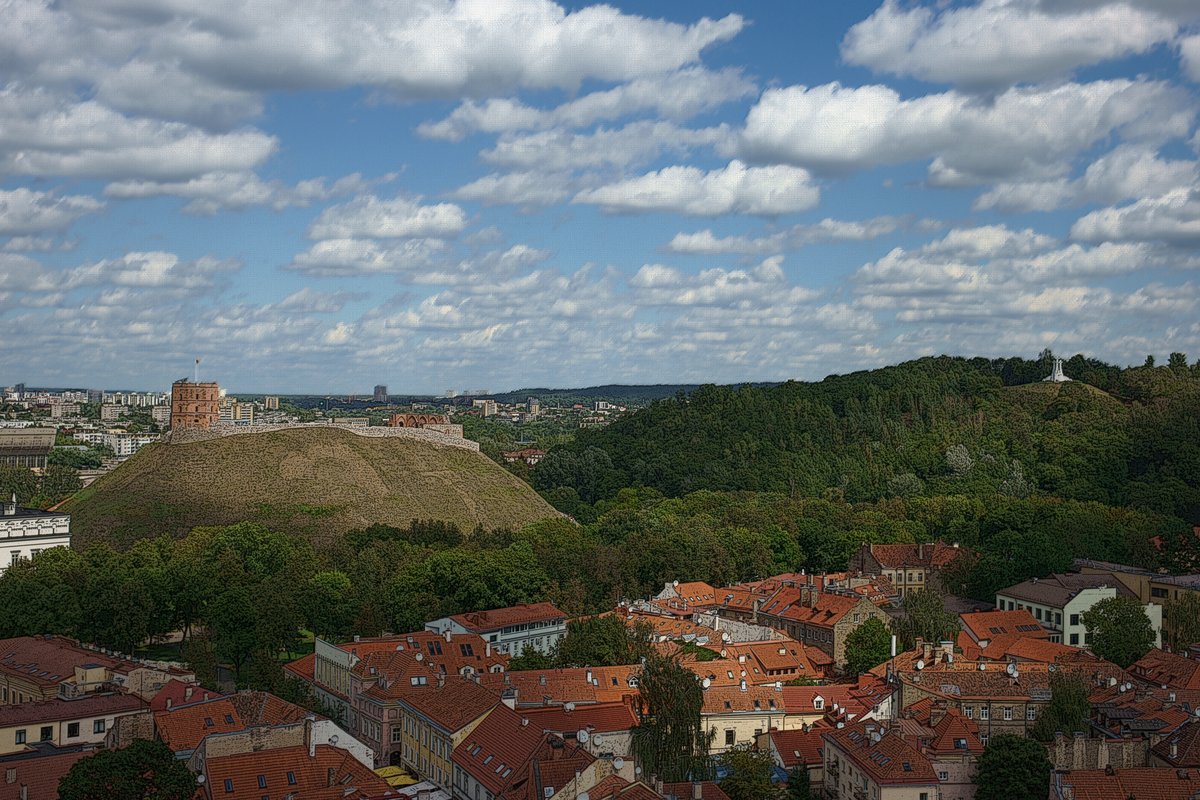 View from Old University tower in Vilnius showing Castle and Three Crosses Hills under a typical Lithuanian August sky