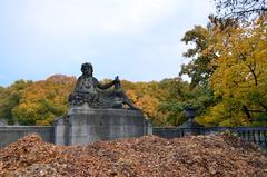 Dead autumn leaves piled before Pfalz von August Drumm statue on Luitpoldbrücke in Munich