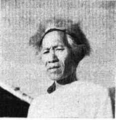 Mizo hunter wearing a traditional fur cap and holding a weapon