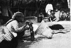 Lushai workers hand ginning cotton