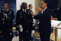 Supervisory archivist Robert Holzweiss explaining exhibit to Lt. Col. Kelvin Brown during tour at George W. Bush Presidential Library and Museum
