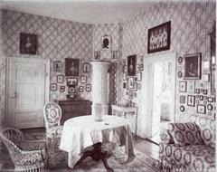 Cozy living room interior at Schloss Wolfsgarten with traditional tiled stove and classic furnishings