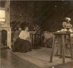 Eleonore Großherzogin v. Hessen und bei Rhein sitting in armchair talking with Princess Viktoria von Battenberg in Wolfsgarten fireplace room 1906