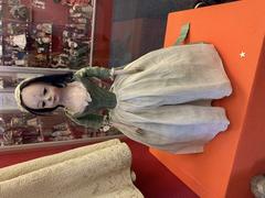 Vintage doll in a glass display case at the Museum of Childhood in Edinburgh
