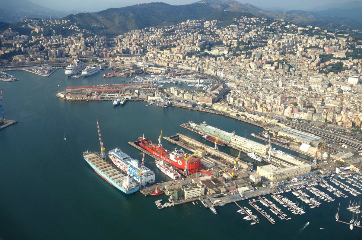 Aerial view of the Harbour of Genoa in Italy with docks, ships, and cityscape