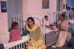 Women and children sitting in the children’s ward of All-India Institute of Medical Sciences during Jacqueline Kennedy's visit