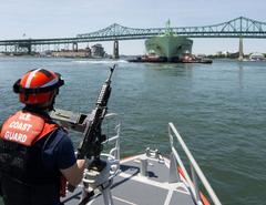 Coast Guard Station Boston crewmember Pat King on 45-foot response boat escorting LNG tanker in Boston Harbor