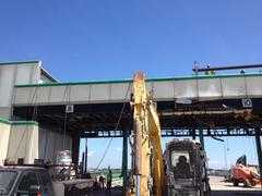 Demolition of Tobin Bridge toll booths on August 21, 2014 with heavy machinery and debris
