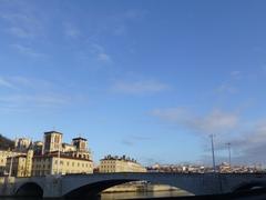 Saint-Jean Cathedral and Pont Bonaparte in Lyon under a cloudy sky