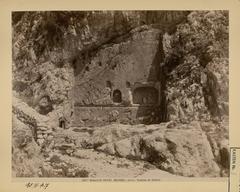 Ancient rock fountain of Castalia with historical stone basin