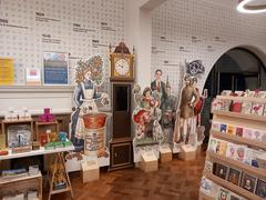 Museum of Oxford gift shop interior with books, postcards, toys, clothes, and food items related to Oxford history