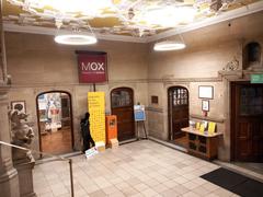 Entrance to the Museum of Oxford inside Oxford Town Hall with three museum doors on the left and main Oxford Town Hall entrance on the right