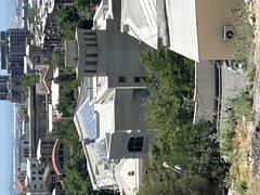 Behind view of Prime Minister's Residence in Yerevan with modern architecture and trees in June 2023