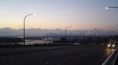 Early morning view of Gladesville Bridge with Sydney Harbour Bridge on the left and Anzac Bridge towers visible on the right, looking east towards the City of Sydney
