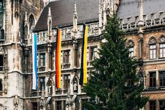Flags of Bavaria, Germany and Munich at the New Munich Town Hall with traditional Christmas tree